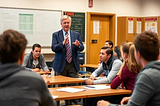 Lindsey Graham speaking to students on Career Day. “Oh, and when you visit Mar-a-Lago, bring lube.” Image by Deep AI. Prompt by Catherne La Grange.
