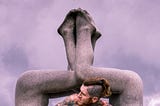 Photo of tattoo man inside of an outdoor sculpture.