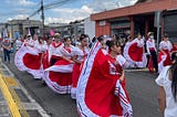 A traditional Costa Rican parade with young dancers dressed in red