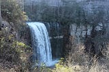 A scenic view of a waterfall from above