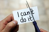 “I can’t do it” written on a sticky note with scissors cutting off the apostrophe t.