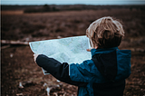 a child looking at a map