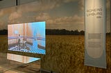 An exhibition room with a video playing