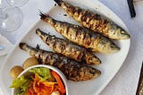 A plate of grilled sardines