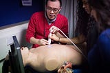 Students being shown how to use ultrasound machine