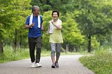older couple jogging in park