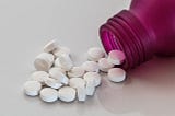 pills spilling out of pill bottle