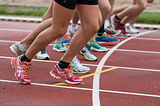 Photo shows runners’ legs ready to start.