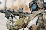 Special Forces Green Beret armoured and in a gunfight