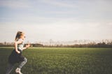 Young girl running across a field