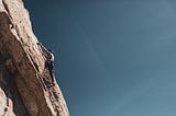 Climber on a Large Cliff