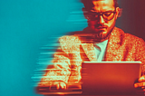 A digitally manipulated image of a man in his thirties with glasses, wearing a textured jacket, and focused intently on a tablet device. The image has a motion blur effect on the left side, creating a sense of speed or digital distortion. The background is split with vibrant teal on the left and deep red on the right, adding to the futuristic, technology-driven aesthetic.