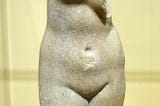 Public domain, (cc-zero), photo by Daderot, Description: Aphrodite statuette, Greek, late Hellenistic of a type found in Egypt, 50 BC — 50 AD, crystalline Parian marble — Fitchburg Art Museum