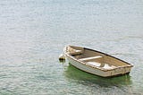 Empty vintage rowboat on a lake