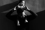 Black and white photo of a father holding young child.