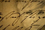 Image shows the brownish background of an old handwritten letter, with words in cursive writing on it, and to the right of the image you see the face of a woman looking into the lense with a worried expression.