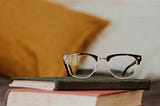 Image of reading glasses with books