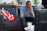 man watching political news on tv