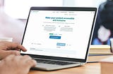 A person working on a laptop displaying the Rembrandt Editor accessibility tool.