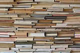 A wall of books piled on top of each other