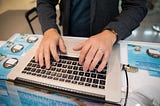 A man typing on a laptop