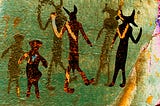 Cave art depicting three humanoid figures. The image has been colorized in surreal golds, greens, oranges and pinks, giving it a mysterious psychedelic look.