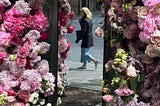 mirror reflection of a woman walking by and floral arch | © pockett dessert, blooms