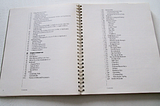 Spiral-bound tech manual opened to Table of Contents.