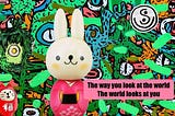 Colorful illustration by artist Francois Top featuring a white rabbit doll dressed in a pink kimono standing in front of a vibrant mural filled with abstract faces, eyes, plants, and colorful shapes. A small red Japanese-style figurine appears in the lower left corner, and a circular symbol with the letter “S” appears in the upper right. A pink text box reads: “The way you look at the world. The world looks at you.”