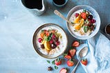 Two bowls containing healthy food sits on the table