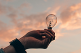 Representation of ideas — Hand holding a light bulb