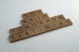 Wooden scrabble letters spelling out Tomorrow and Yesterday