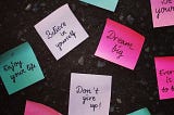 An image that contains papers with motivational quotes written on them