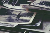 A pile of old, black-and-white photos.