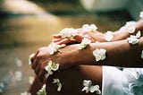 A woman is adorned in white flowers.