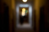 Blurry lights down an out-of-focus hallway. Worms All by Jim Latham