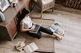 brand journalist on laptop sitting on floor