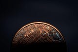 old penny faded on black background, best personal finance advice