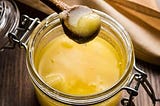 A jar of ghee with spoon