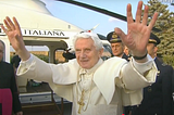 Pope Benedict waves both hands, bidding a final farewell before boarding the helicopter on February 28th, 2013, following his resignation.