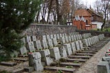 3 identical rows of identical headstones each with a cross across its center