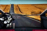 Interior of a car with a large panoramic LED monitor showing the remaining part of the road ahead, not seen in regular cars.