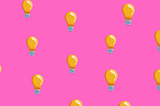 Lightbulbs on top of a bright pink background