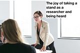 UX researcher standing and leading with a smile after sharing a strong, data-supported point of view