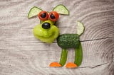 A cute little dog made out of vegetables. Notably, Celery is not involved.