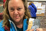 Tired woman holds pilgrim passport