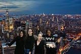 Four women standing in front of an aerial view of Manhattan.