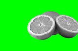 Grey-scale cross-sectional image of an orange showing segments, set against a vivid lime green background.