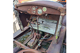 The vehicle in the photo is one I took at my mechanic’s place of a Star Car by Durant Motors, circa late 1920s. It shows the front seat area, though the seats are missing. It is quite rusty and many of the floorboards (which are actual wooden boards) are missing, too.