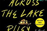 A brightly lit house in the darkness sits between the title and the author. It reflects in the lake water.